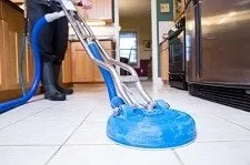 person cleaning a tile floor