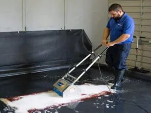 man cleaning a floor with a machine